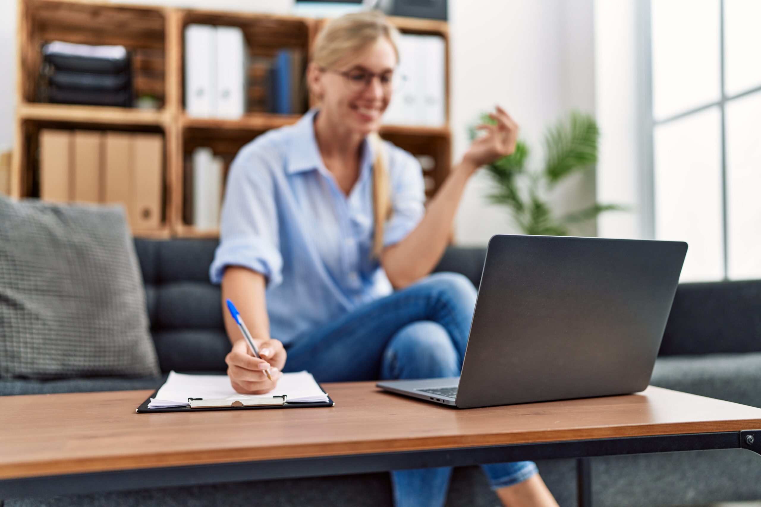 Young blonde woman having psychology online session at clinic
