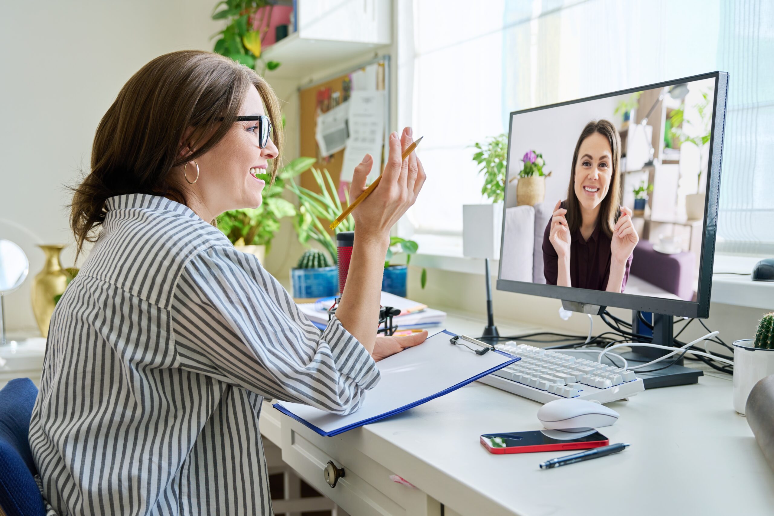 Mature woman talking online with young female using video call